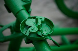 Inner workings of a bike bell painted green