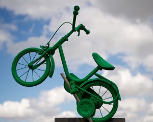 Small green painted child's bike with stabilisers 