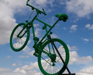 Green painted mountain bike against the sky