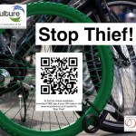 Green bike wheel locked to another bike with title, logos & QR code
