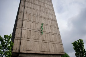 three green painted bikes emerge from the wall above Roehampton Library