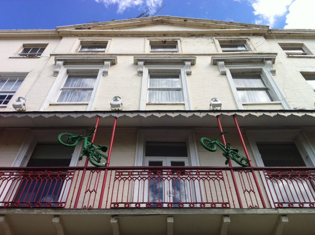 Two green painted children's bikes prepare to leap from the balcony of Marine Studios