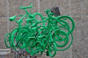 Side on view of the 7 green bikes - looking like a jumble of bikes